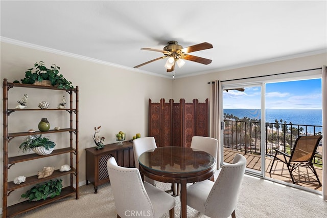 dining space with crown molding, light carpet, and a ceiling fan