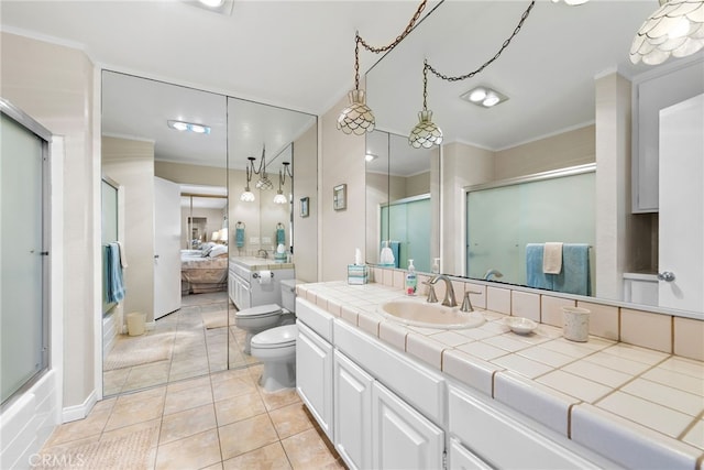 bathroom featuring crown molding, toilet, tile patterned flooring, and a shower with shower door