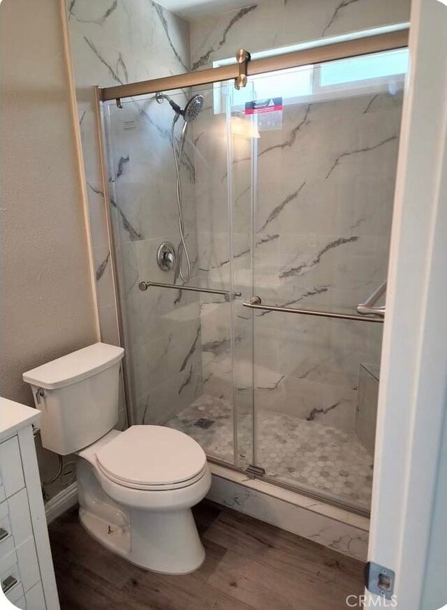 5912 Santa Ana Ave, Riverside, CA 92505 - bathroom featuring toilet, wood finished floors, vanity, and a marble finish shower