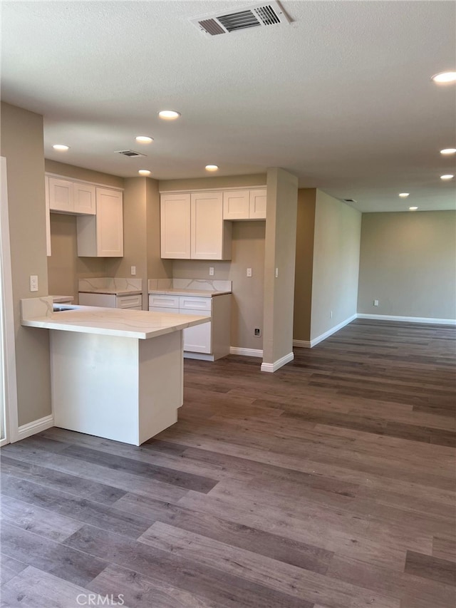 5912 Santa Ana Ave, Riverside, CA 92505 - kitchen featuring baseboards, visible vents, and white cabinets