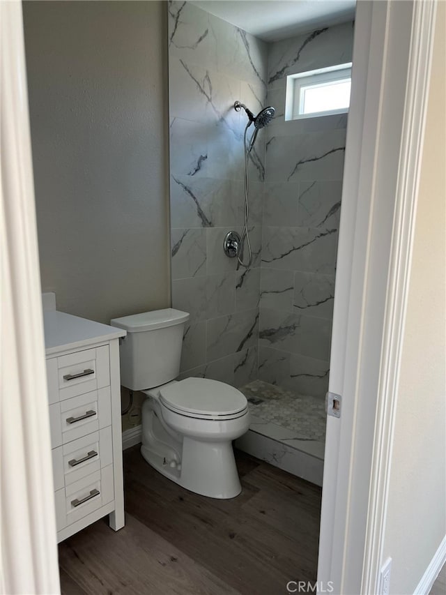 5912 Santa Ana Ave, Riverside, CA 92505 - bathroom featuring toilet, vanity, a marble finish shower, and wood finished floors