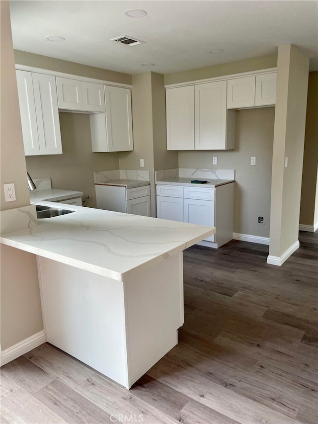 5912 Santa Ana Ave, Riverside, CA 92505 - kitchen featuring white cabinets, visible vents, baseboards, light stone countertops, and wood finished floors