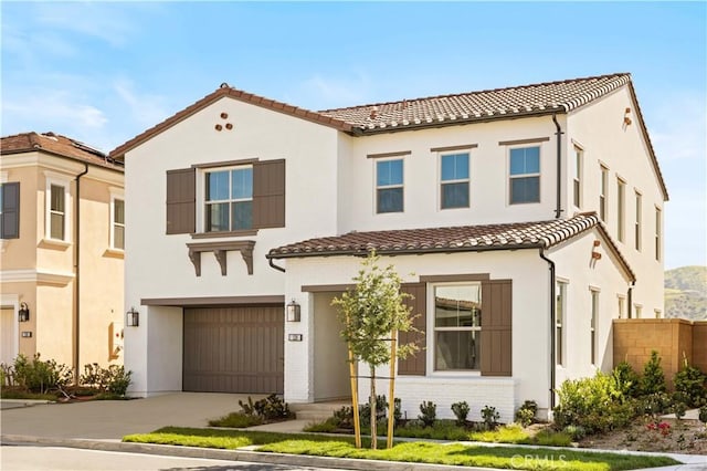 128 Mossvine, Irvine, CA 92618 - mediterranean / spanish-style home with a garage, stucco siding, driveway, and a tile roof