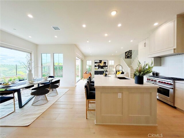 128 Mossvine, Irvine, CA 92618 - kitchen featuring high end range, visible vents, a wealth of natural light, and a sink