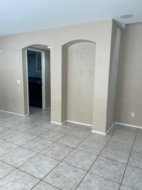 11433 Mountain View Dr Unit 62, Rancho Cucamonga, CA 91730 - empty room with arched walkways, light tile patterned floors, and baseboards