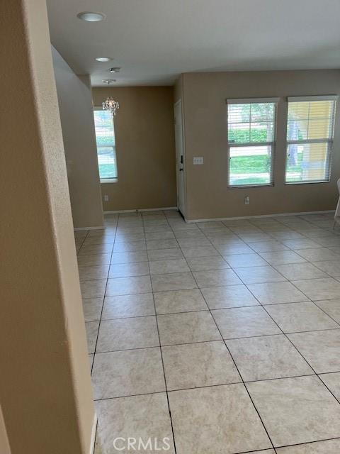 11433 Mountain View Dr Unit 62, Rancho Cucamonga, CA 91730 - empty room featuring light tile patterned floors, a chandelier, baseboards, and recessed lighting