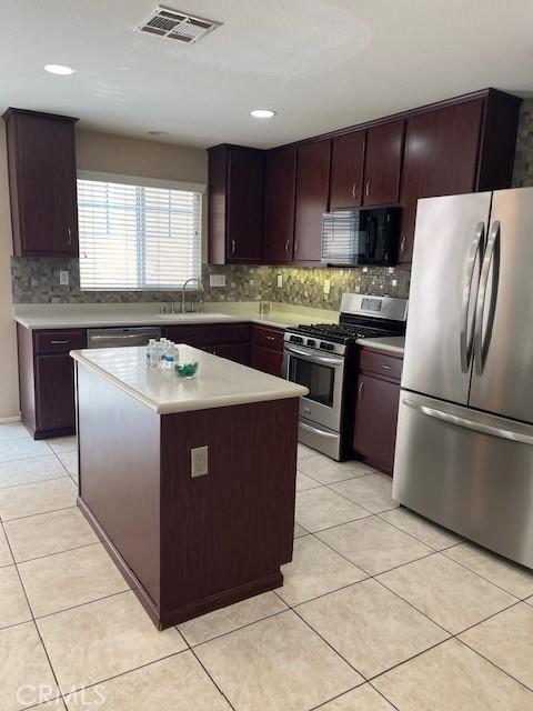 11433 Mountain View Dr Unit 62, Rancho Cucamonga, CA 91730 - kitchen with stainless steel appliances, backsplash, light countertops, light tile patterned floors, and recessed lighting