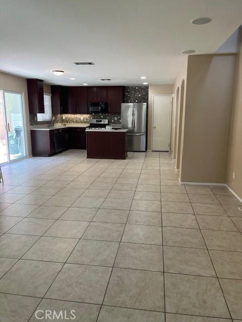 11433 Mountain View Dr Unit 62, Rancho Cucamonga, CA 91730 - kitchen featuring stainless steel appliances, tasteful backsplash, light tile patterned floors, light countertops, and a center island