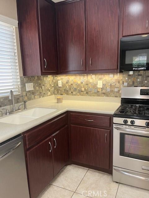 11433 Mountain View Dr Unit 62, Rancho Cucamonga, CA 91730 - kitchen featuring stainless steel appliances, light tile patterned floors, light countertops, and tasteful backsplash