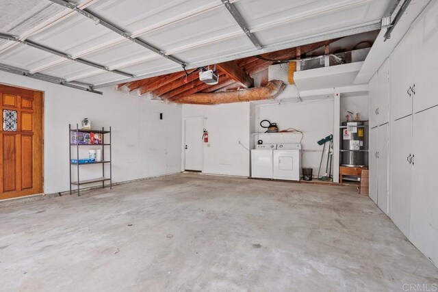 garage with a garage door opener, washing machine and dryer, and secured water heater