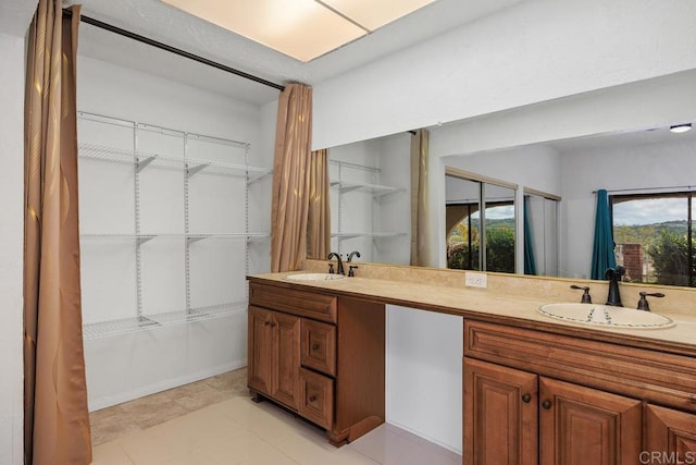 full bathroom with double vanity and a sink