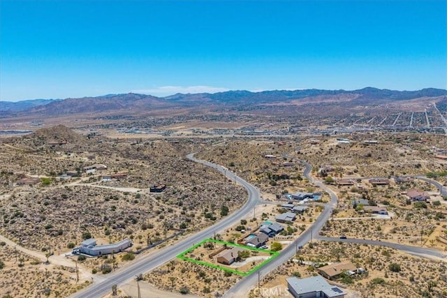 birds eye view of property with a mountain view and a desert view