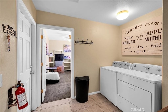 washroom with separate washer and dryer, laundry area, light tile patterned floors, baseboards, and a ceiling fan