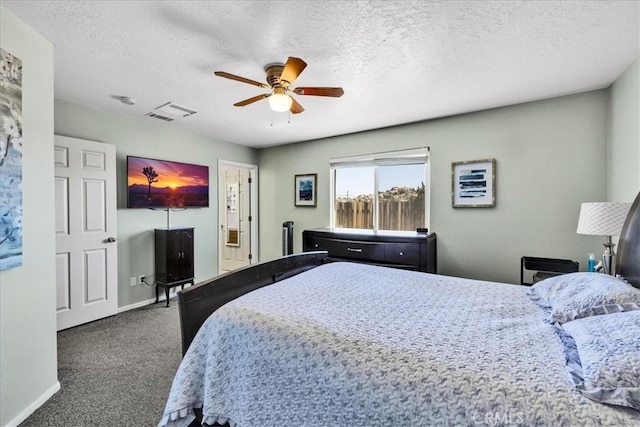 bedroom featuring a textured ceiling, baseboards, a ceiling fan, and carpet floors