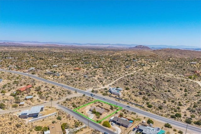 aerial view featuring a rural view, view of desert, and a mountain view