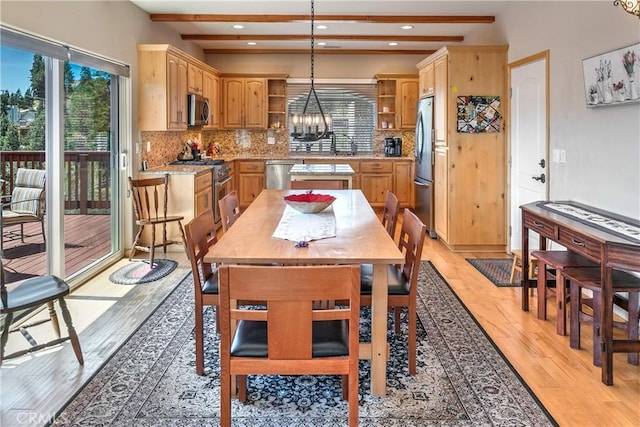 dining room featuring a chandelier, light wood-type flooring, recessed lighting, and beamed ceiling