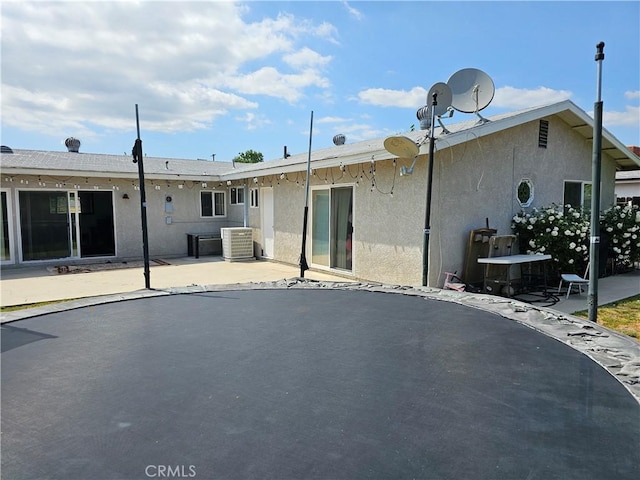 9526 Fullbright Ave, Chatsworth, CA 91311 - back of property featuring a patio, central air condition unit, and stucco siding