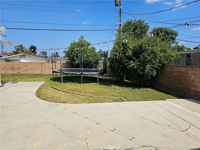 9526 Fullbright Ave, Chatsworth, CA 91311 - view of yard featuring a trampoline, a fenced backyard, and a patio area