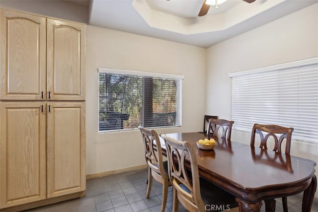 23684 Valley View Rd, Calabasas, CA 91302 - dining room featuring light tile patterned flooring, a ceiling fan, and a tray ceiling