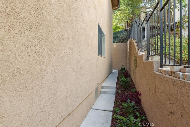 23684 Valley View Rd, Calabasas, CA 91302 - view of property exterior featuring fence, stucco siding, and stairs
