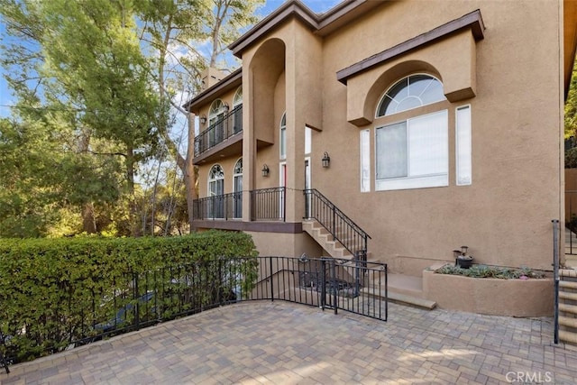23684 Valley View Rd, Calabasas, CA 91302 - view of exterior entry featuring fence, stucco siding, and a patio area