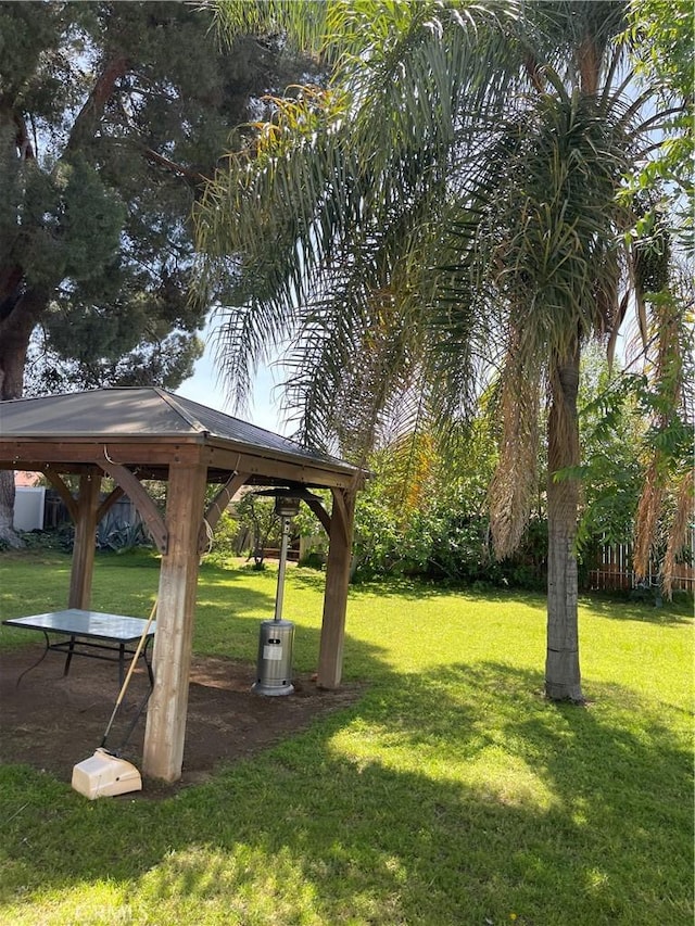 view of property's community with a gazebo and a yard