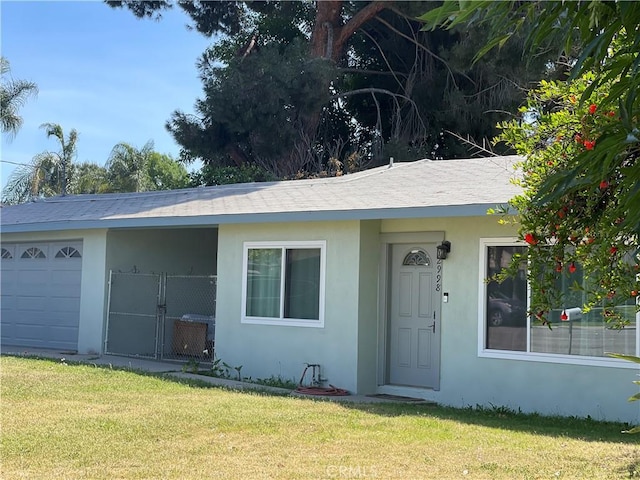 2998 Mary St, Riverside, CA 92506 - ranch-style house featuring stucco siding, a front lawn, and a garage