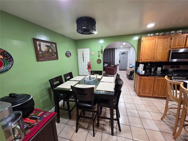 2998 Mary St, Riverside, CA 92506 - dining room featuring light tile patterned floors, arched walkways, and recessed lighting