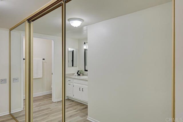 3168 Via Vis Unit B, Laguna Woods, CA 92637 - bathroom with wood finished floors, vanity, baseboards, and toilet