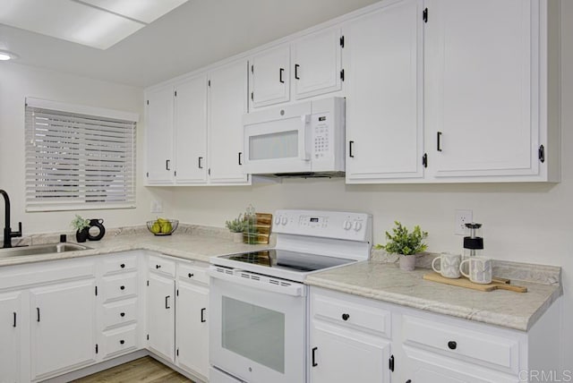 3168 Via Vis Unit B, Laguna Woods, CA 92637 - kitchen featuring white appliances, a sink, white cabinets, light wood finished floors, and light stone counters