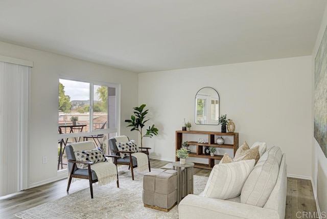 3168 Via Vis Unit B, Laguna Woods, CA 92637 - living area with plenty of natural light, light wood-style floors, and baseboards