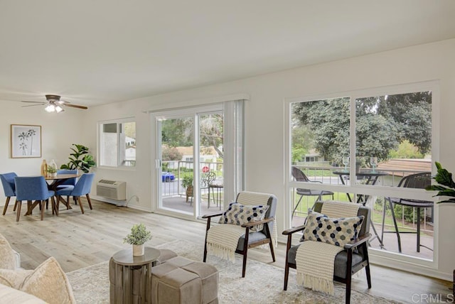 3168 Via Vis Unit B, Laguna Woods, CA 92637 - living room with plenty of natural light, ceiling fan, light wood finished floors, and a wall mounted AC