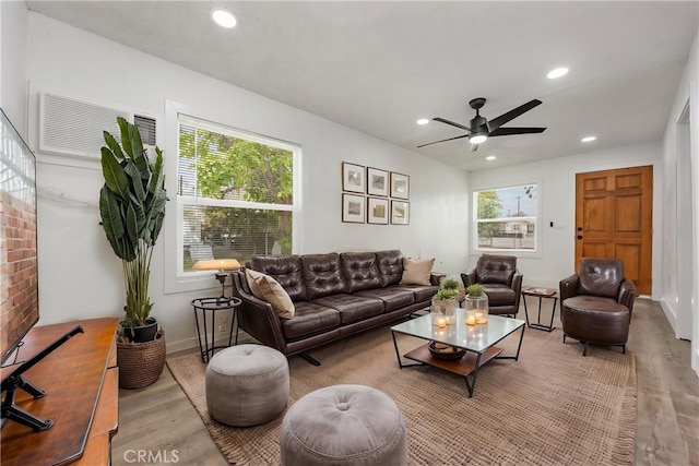 living area featuring wood finished floors, recessed lighting, a ceiling fan, and baseboards