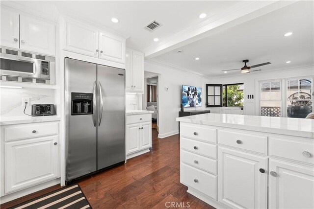 kitchen with built in appliances, visible vents, crown molding, and light countertops