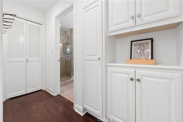 corridor featuring dark wood finished floors