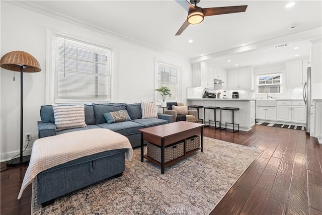 living area featuring ornamental molding, dark wood-style floors, recessed lighting, and ceiling fan
