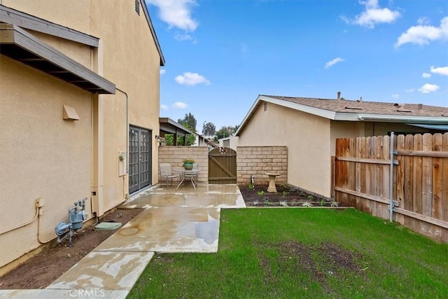 810 Hacienda Dr, Riverside, CA 92507 - view of yard with fence, a patio area, and a gate