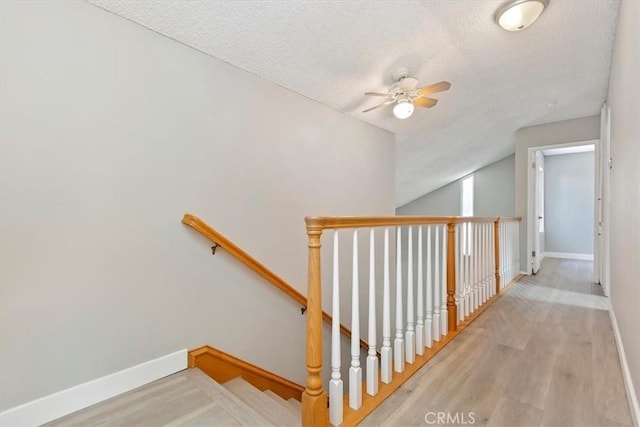 810 Hacienda Dr, Riverside, CA 92507 - staircase with a textured ceiling, ceiling fan, wood finished floors, and baseboards