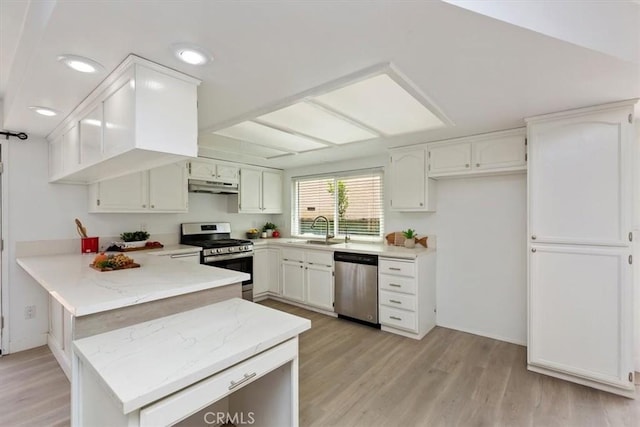 810 Hacienda Dr, Riverside, CA 92507 - kitchen with light wood-style floors, under cabinet range hood, appliances with stainless steel finishes, a sink, and a peninsula