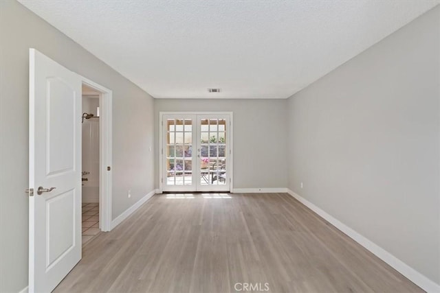 810 Hacienda Dr, Riverside, CA 92507 - spare room with visible vents, french doors, light wood-style flooring, and baseboards