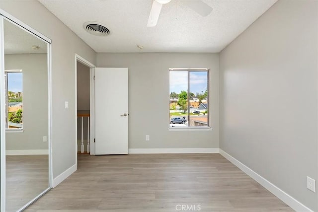 810 Hacienda Dr, Riverside, CA 92507 - empty room featuring light wood-style flooring, ceiling fan, baseboards, visible vents, and a textured ceiling