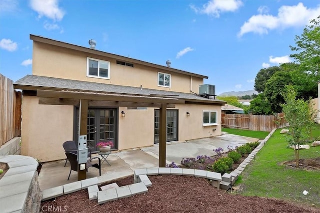 810 Hacienda Dr, Riverside, CA 92507 - back of property featuring a fenced backyard, stucco siding, central AC unit, roof with shingles, and a patio area