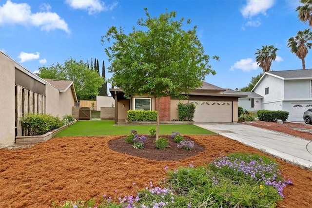 810 Hacienda Dr, Riverside, CA 92507 - view of front of house featuring concrete driveway, a gate, a front yard, an attached garage, and fence