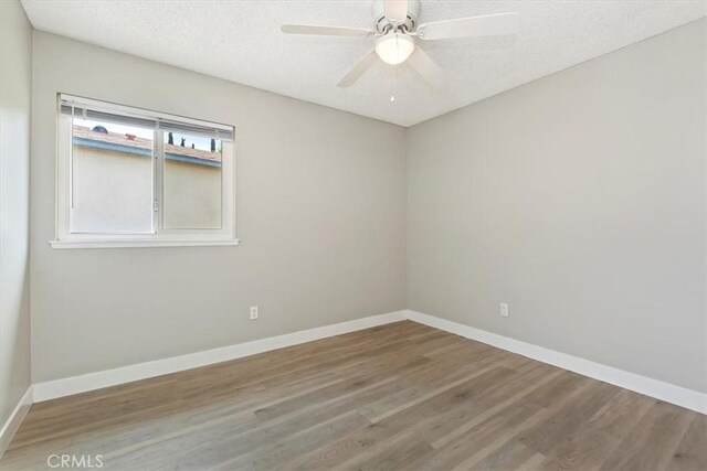 810 Hacienda Dr, Riverside, CA 92507 - spare room with a textured ceiling, wood finished floors, and baseboards