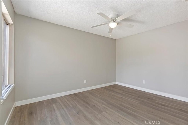 810 Hacienda Dr, Riverside, CA 92507 - unfurnished room featuring a textured ceiling, wood finished floors, a ceiling fan, and baseboards