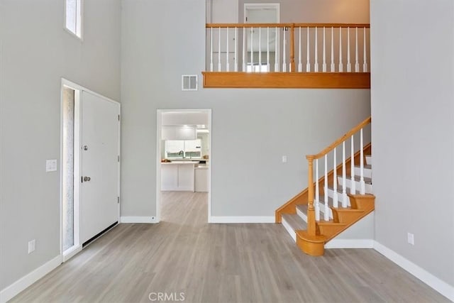 810 Hacienda Dr, Riverside, CA 92507 - entryway featuring a high ceiling, visible vents, wood finished floors, and baseboards
