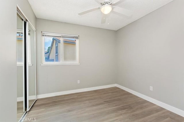810 Hacienda Dr, Riverside, CA 92507 - unfurnished bedroom with a textured ceiling, ceiling fan, baseboards, a closet, and wood finished floors