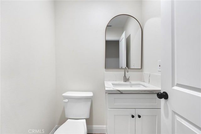 bathroom featuring toilet and vanity