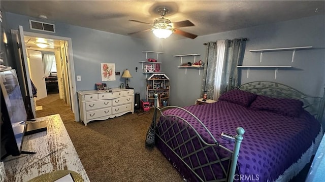 bedroom with visible vents, ceiling fan, and carpet