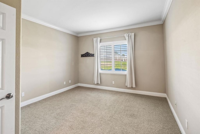 empty room with crown molding, carpet floors, and baseboards